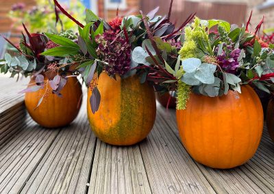 Halloween flower arrangements in pumpkins